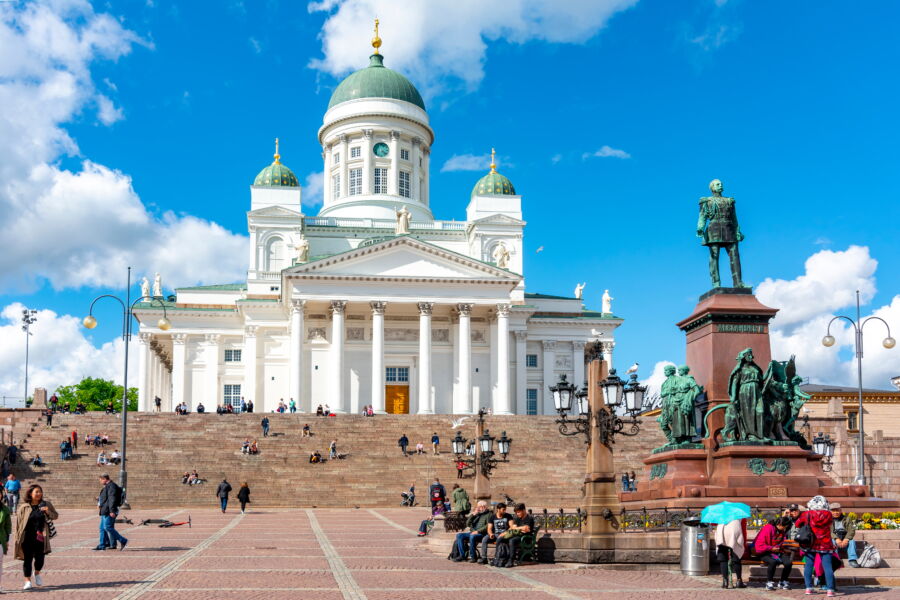 The iconic Helsinki Cathedral, located on Senate Square, features striking white columns and a green dome, symbolizing Finland