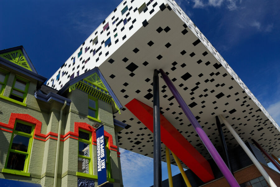 The Sharp Centre, an innovative structure, is suspended above an arts supply store in Toronto, Canada