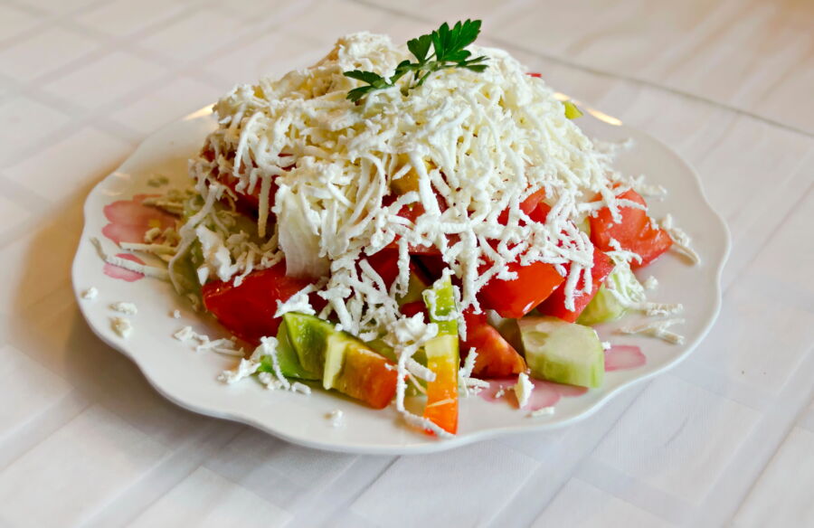 Bulgarian mixed vegetable salad with sliced ​​white cheese on top called also Shopska salad, Sofia, Bulgaria