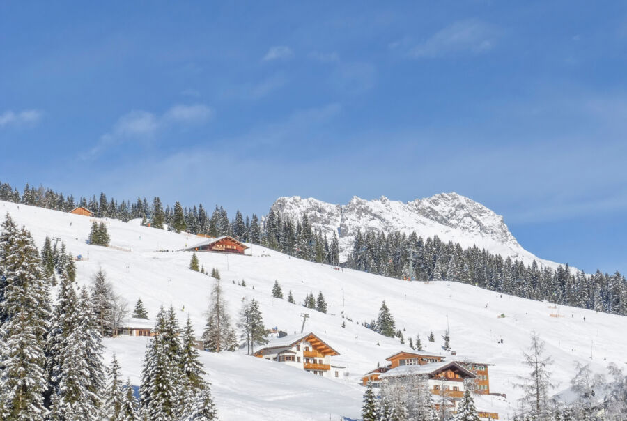 Scenic view of the famous Lech ski resort nestled in the Austrian Alps, showcasing snow-covered mountains and ski slopes