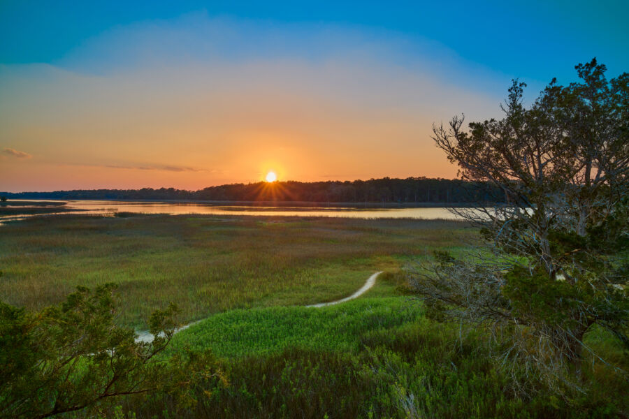 Sunset over Skidaway Island State Park, viewed from the observation tower, casting warm colors across the sky and landscape