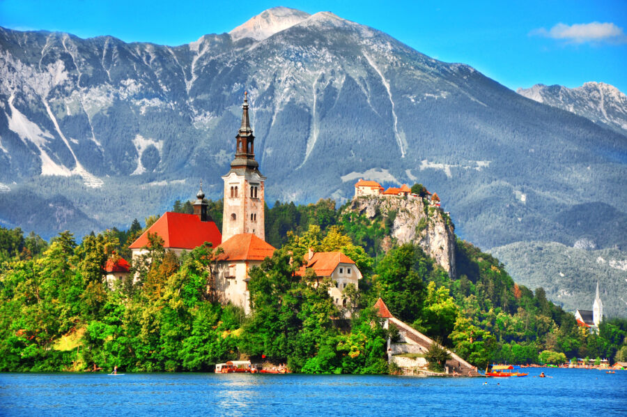 Scenic view of Bled Lake in Slovenia, featuring the island with the Pilgrimage Church and the historic castle on a cliff