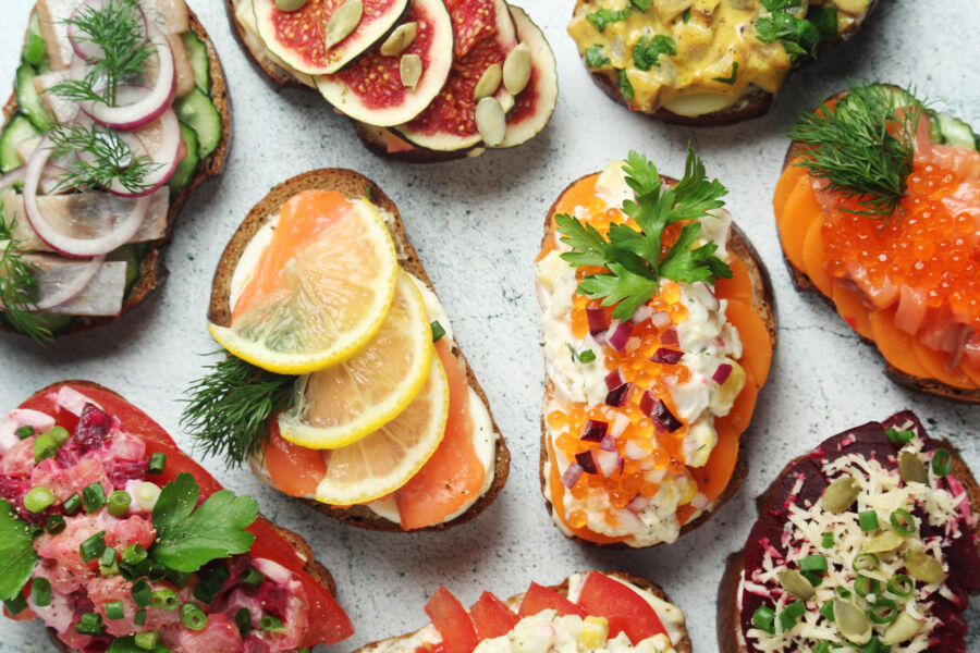 Traditional Scandinavian open-faced sandwich, Smørrebrød, beautifully arranged with various toppings on dark rye bread