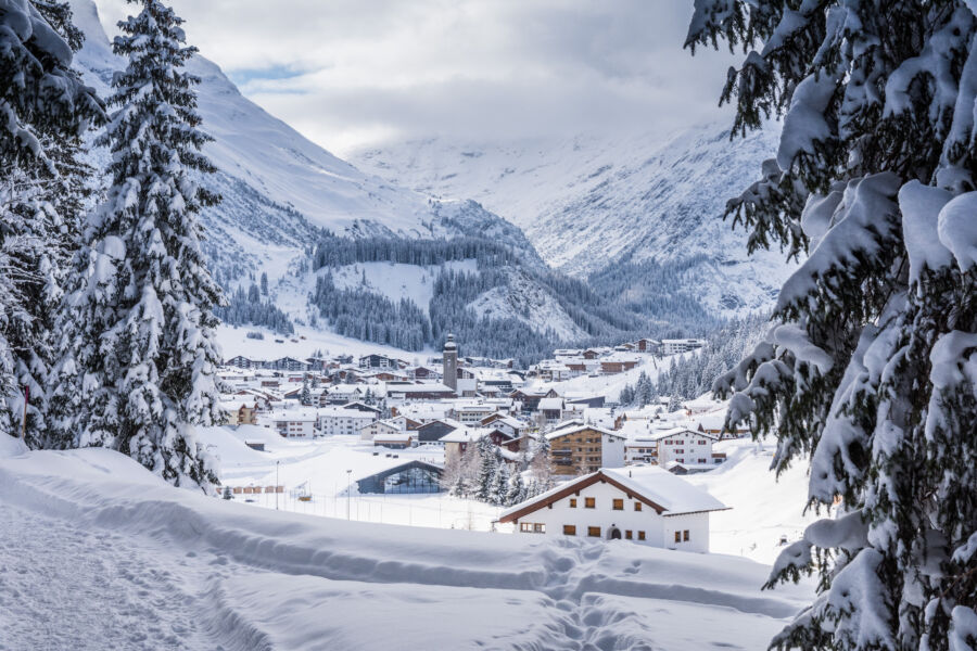 Panoramic view of Snowy Lech, Austria, showcasing snow-covered mountains and charming alpine village scenery