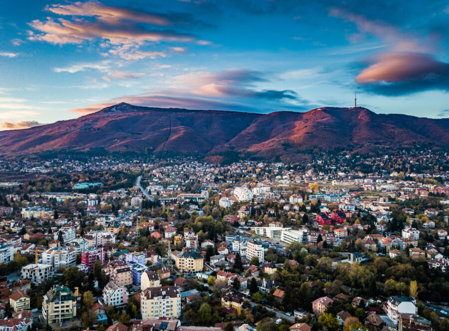 Beautiful drone shot of a vivid sunrise over Sofia, Bulgaria - impressive image with colourful skies and amazing aerial views over the city.