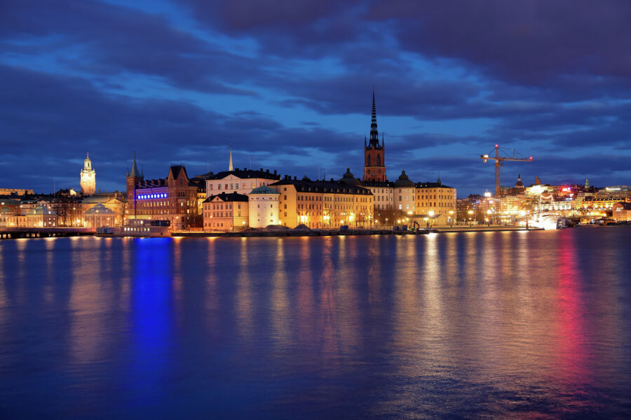 Serene evening panorama of Riddarholmen island and Gamla Stan, featuring Stockholm's historic buildings and tranquil waters