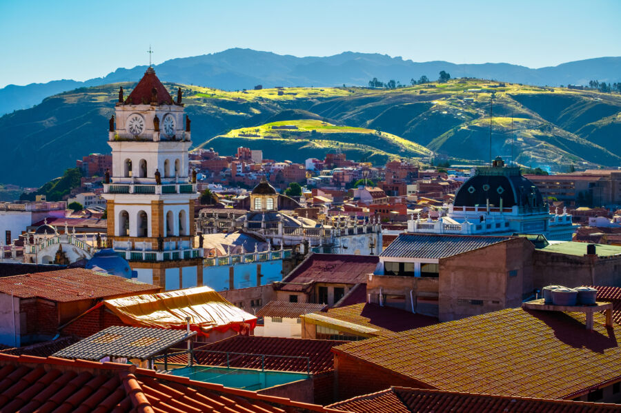 Bright, sunny day in Sucre, Bolivia, showcasing the city's vibrant architecture and clear blue skies