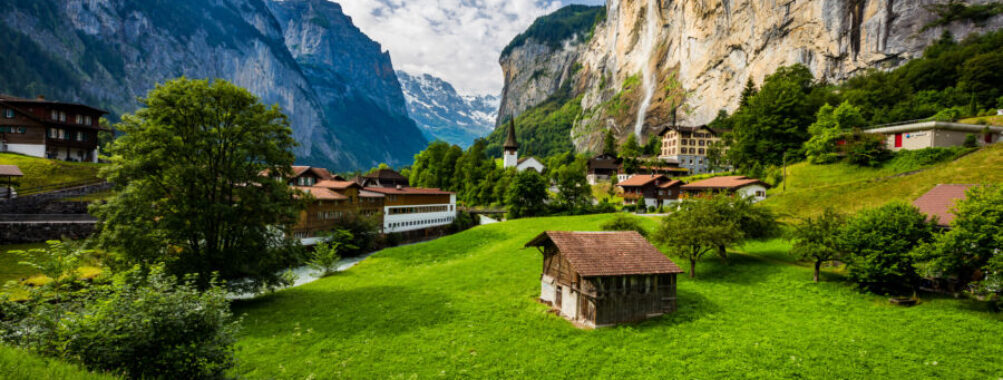 Stunning view of Lauterbrunnen in the Swiss Alps, featuring the majestic Staubbach waterfall cascading down the valley