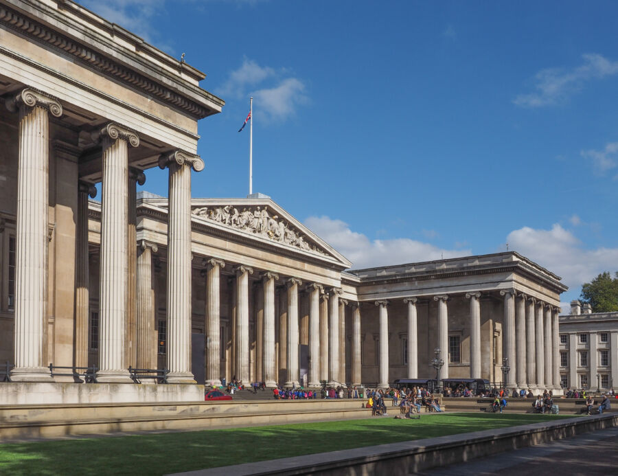 The British Museum's exterior in London, featuring its majestic columns and architectural elegance against a clear sky