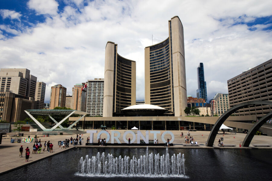 Toronto's skyline with notable buildings and a sign, illustrating the vibrant urban landscape of the city