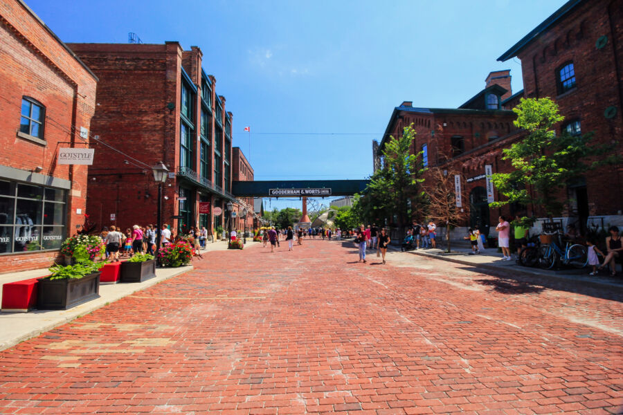 Historic Toronto Distillery District featuring cobblestone streets, vintage buildings, and vibrant shops and restaurants