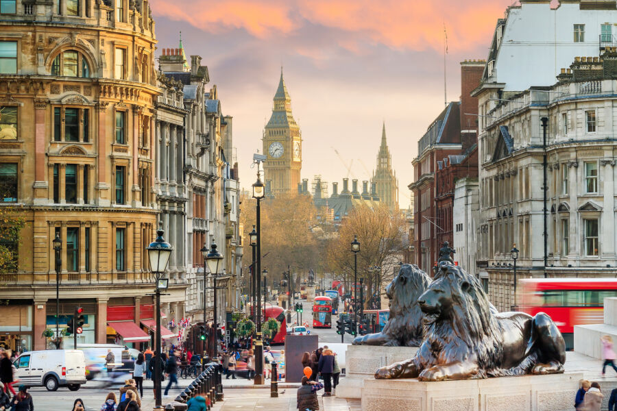 Bustling Trafalgar Square filled with tourists admiring the iconic landmarks and vibrant atmosphere of the city