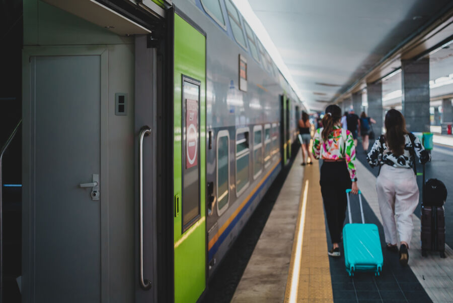 Central railway station in Naples, Italy, bustling with travelers and trains, showcasing vibrant travel activity