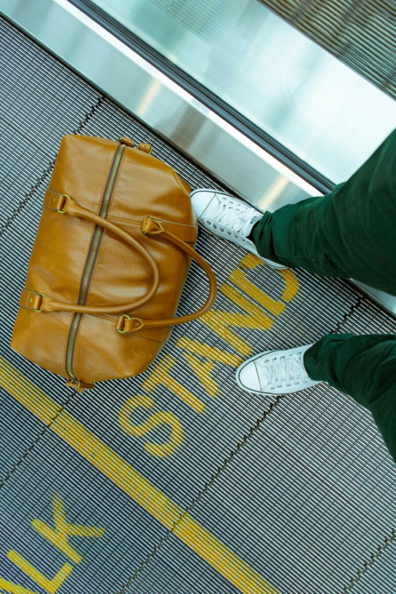 Traveler with brown leather bag