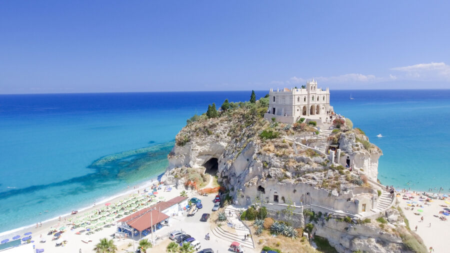 Aerial view of Santa Maria dell'Isola Monastery overlooking Tropea Beach, showcasing the stunning coastal landscape of Italy