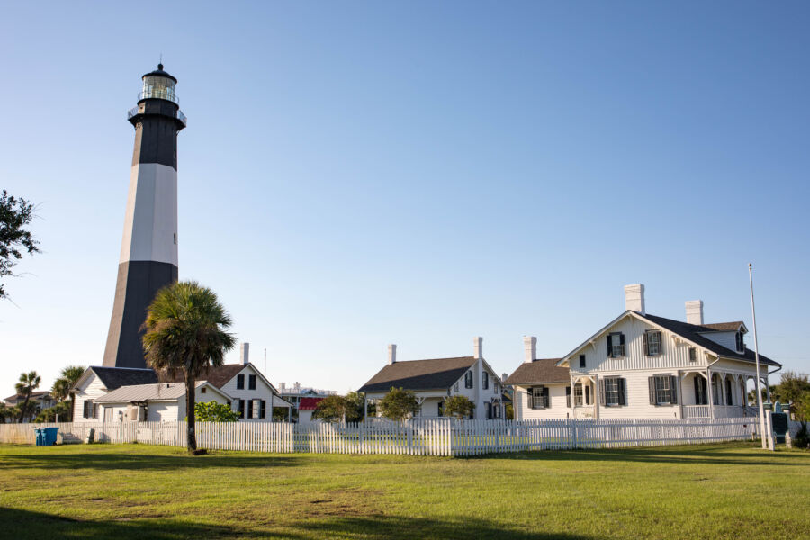 The iconic Tybee Island Lighthouse, with its black and white stripes, overlooks the beach near Savannah, Georgia