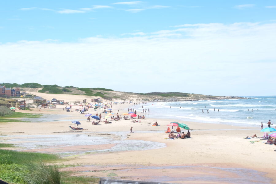 Panoramic view showcasing the serene beauty of Uruguay's beach, with golden sands and gentle waves under a clear sky