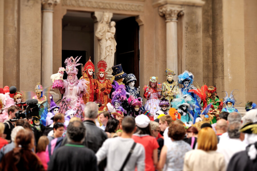 Colorful masks adorn participants at the Venice Carnival, showcasing the vibrant spirit of this traditional Italian festival