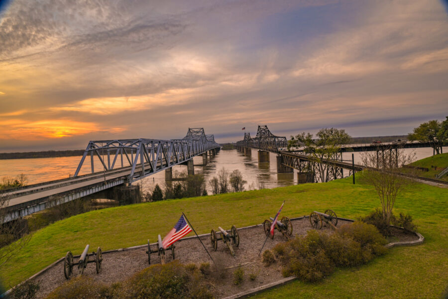 The Vicksburg bridge crosses the Mississippi River, showcasing the landscape and infrastructure of the region