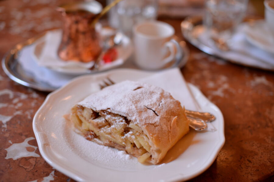 Close-up of a slice of Apfelstrudel served at Cafe Central in Vienna, Austria, showcasing its flaky pastry and apple filling