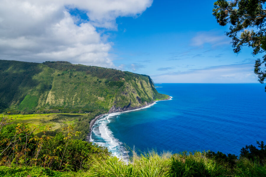 Scenic Waipio Valley with its lush landscape and pristine beach, highlighting the natural beauty of Hawaii's Big Island