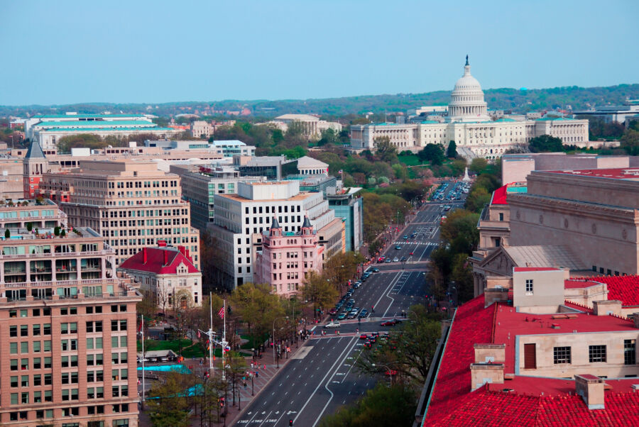 Aerial view of Capitol Hill building amidst the Washington DC cityscape, showcasing its architectural grandeur and surroundings