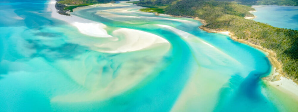 Scenic view of Hill Inlet at Whitehaven Beach, showcasing turquoise waters and white sands on Whitsunday Island, Queensland