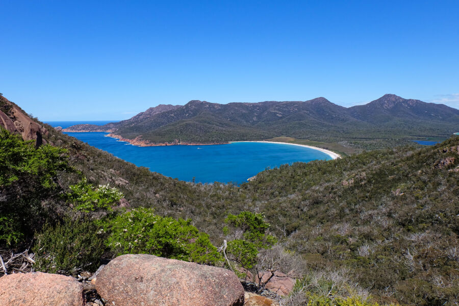 Panoramic landscape of Freycinet National Park featuring the iconic Wineglass Bay amidst Tasmania's natural beauty