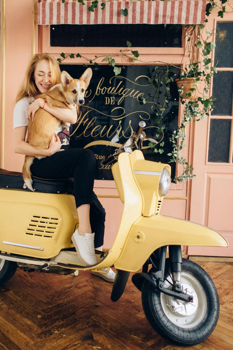 Woman With Pet Dog On A Scooter