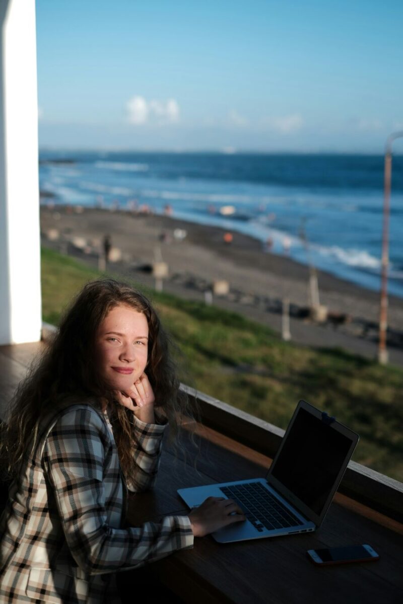 Young woman working by the beach